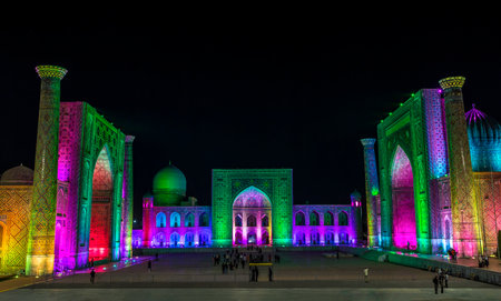 View of Registan square in Samarkand with Ulugbek madrassas, Sherdor madrassas and Tillya-Kari madrassas at night during the color show. Uzbekistanのeditorial素材
