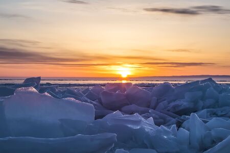 Sunrise over the ice of lake Baikal in winter, Eastern Siberia, Russiaの写真素材
