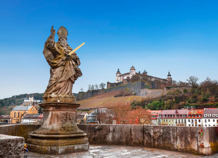 View of the city of Wurzburg, the old Alta Mainbrucke bridge with the sculpture of St. Kilian and the fortress of Marienberg. Bavaria, Germanyのeditorial素材