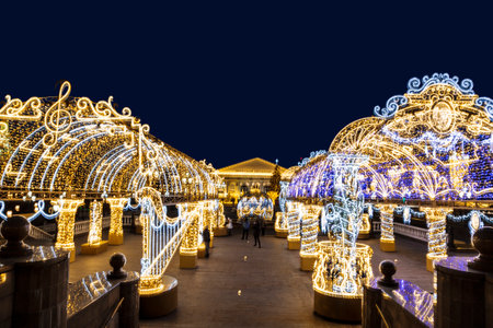Manezhnaya square during New Year and Christmas holidays with glowing multi-colored arch, Moscow, Russiaのeditorial素材