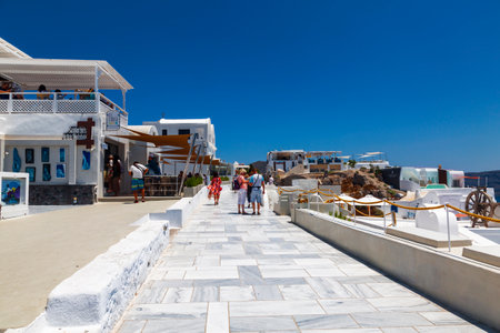 Fira on a sunny summer day with walking tourists. Santorini, Greeceのeditorial素材