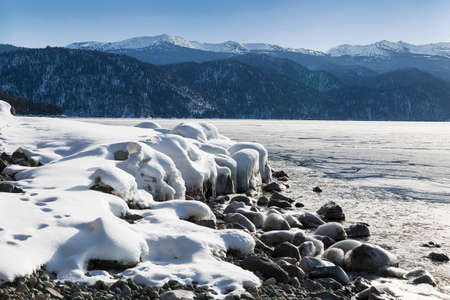 Scenic landscape of lake Teletskoye on a winter day. Altai Republic, Russiaの写真素材