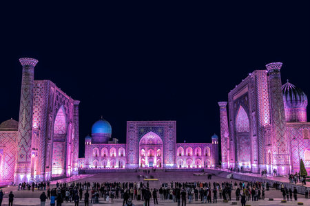 Uzbekistan. View of Registan square in Samarkand with Ulugbek madrasah, Sherdor madrasah and Tillya-Kari madrasah at night with lilac color backlight.のeditorial素材