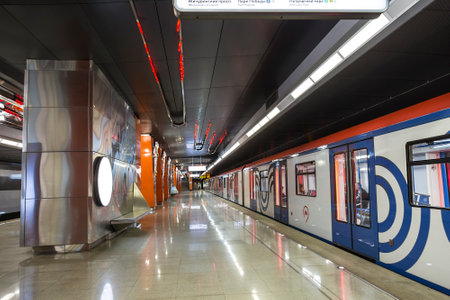 The interior of the Borovskoe Highway station of the Solntsevskaya line of the Moscow Metro and a modern metro train at the platform. Moscow, Russiaのeditorial素材
