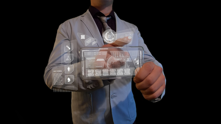 Man with a futuristic screen. The concept of the future interface on a transparent displayの写真素材