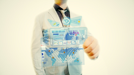 Man with a futuristic screen. The concept of the future interface on a transparent displayの写真素材