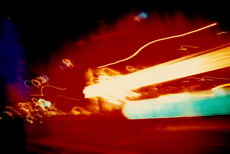 Flows of light from the headlights of cars rushing along and light, illumination of buildings,...
