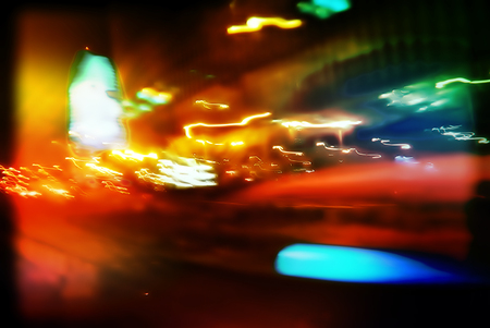 Flows of light from the headlights of cars rushing along and light, illumination of buildings,...