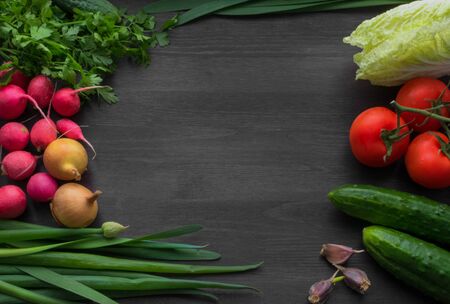 Fresh summer vegetables on a black wooden tableの写真素材