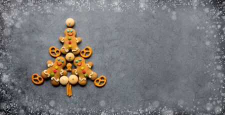 Delicious Christmas gingerbread men.Christmas baking ingredients and supplies on dark...