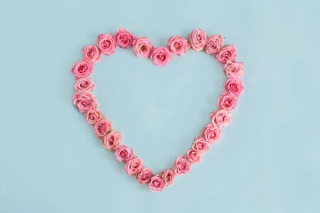Valentine's day heart of delicate pink roses on a blue background.Holiday card, greeting I love you, calendar, banner for the store sales.Spring wreath of flowers a gift to your loved ones. March 8の写真素材