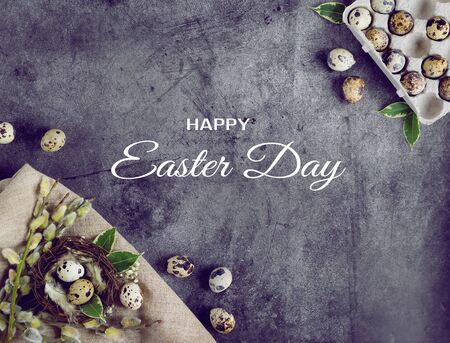 Happy Easter greating card.Quail eggs in a nest on a blue background with green leaves and willow branches.Banner.Spring holiday.Eco friendly.minimalism.Zero Waste.Ecologic.copy space.の写真素材
