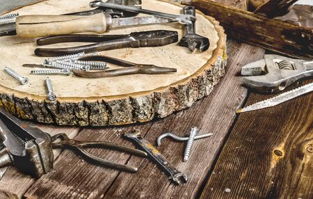 A set of metal tools in the workshop on an old rustic wooden background.concept.Fathers day or labor...