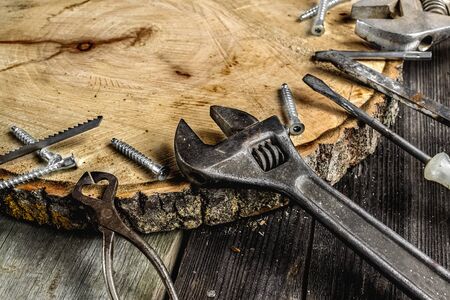A set of metal tools in the workshop on an old rustic wooden background.concept.Fathers day or labor...