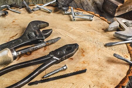 A set of metal tools in the workshop on an old rustic wooden background.concept.Fathers day or labor...