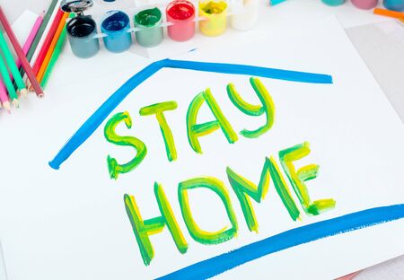 Stay at home. Childrens drawing with gouache paints on a white sheet.Campaign on social networks for the prevention of coronavirusの写真素材