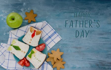 Happy fathers Day.Breakfast for dad.Delicious sandwiches in the form of mens shirts with ties on a plate.The concept of healthy eating.Greeting card or banner. DIY. copy space.top view.Flat layの写真素材