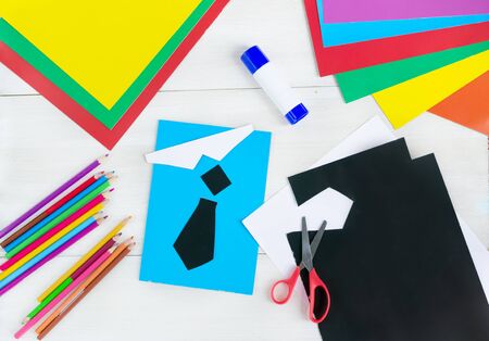 Happy Father's day.I love dad. Making greeting card. Child draws a black tie and blue shirt. DIY concept. Step-by-step photo instruction.Flat lay.Top view. Step 4の写真素材