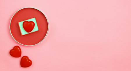 Happy Valentines Day or Mothers Day greeting card with red hearts on pink background.Banner for your store or website.Copy space.Flat lay.Mock upの写真素材