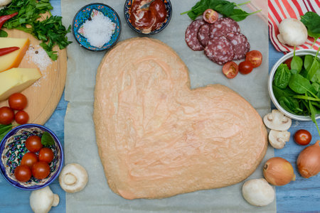 Homemade Delicious pizza heart for Valentine's Day made of yeast-free dough with vegetables, tomatoes, herbs and cheese, prepared at home for festive dinner. Step by step recipe. Instructions. DIY. Step 7の写真素材