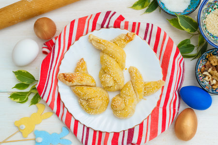 Delicious homemade easter puffs of dough withwith powdered sugar and sesame seeds.Homemade cake in...