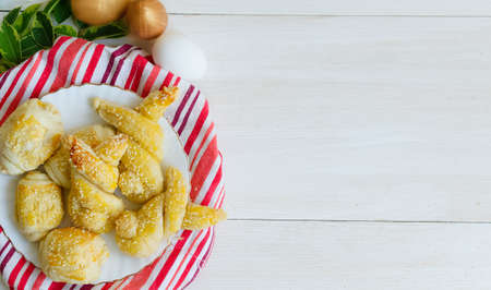 Delicious homemade easter puffs of dough withwith powdered sugar and sesame seeds.Homemade cake in...