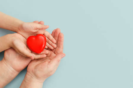 Concept Happy Mothers Day or International Day of Families.Happy womens day.Heart in the hands of...