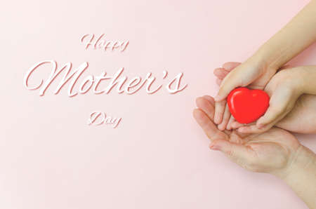 Concept Happy Mother's Day or International Day of Families.Happy women's day.Heart in the hands of...
