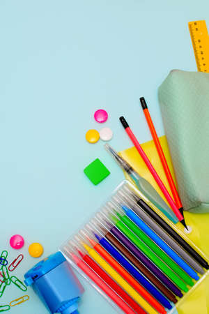 Back to school. Bright colorful school supplies and backpack for school or college on a blue...