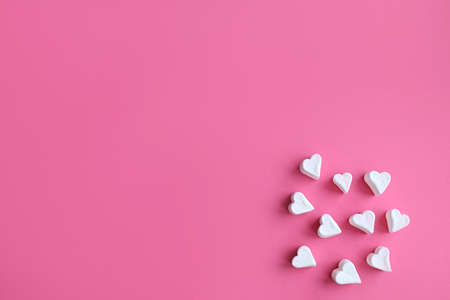 Minimalist Valentines day. White marshmallow hearts on pink pastel background. Composition for Valentins Day, Mothers Day, March 8 or Womens Day.の写真素材