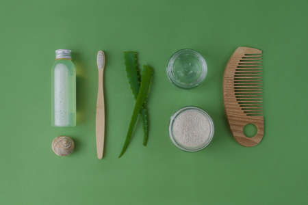 Skin, face, body, and hair care products. Eco-friendly natural cosmetics on a green background. beauty concept. top view. flat layの写真素材