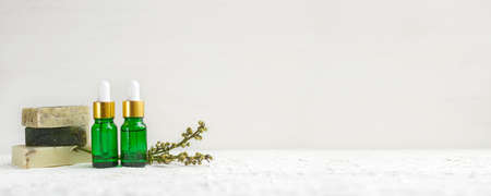 Eco-friendly cosmetic products for skin care. Glass cosmetic bottles and soap with natural oil,...