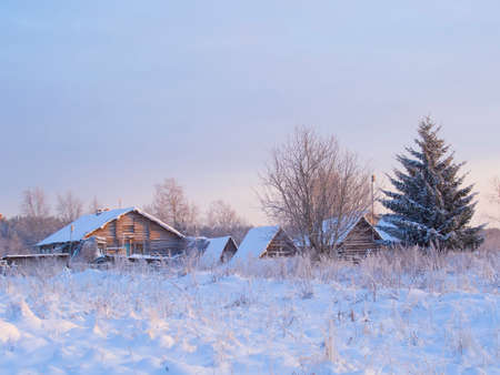 winter view of old farm house in forestの写真素材