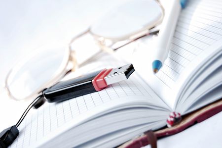 The handle and points lie on a weekly journal