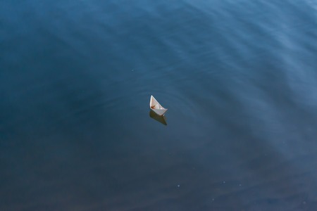Paper boat floating on the riverの写真素材