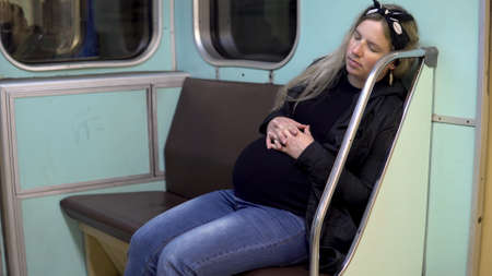 A pregnant woman fell asleep on a subway train. Old subway train carの写真素材