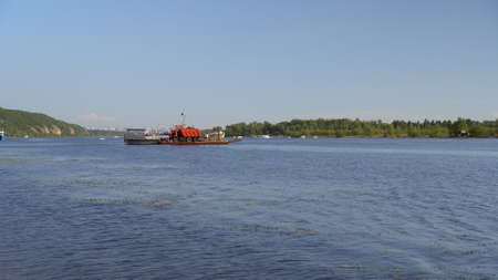 A ship transports a truck to the other side of the river. River View.の写真素材