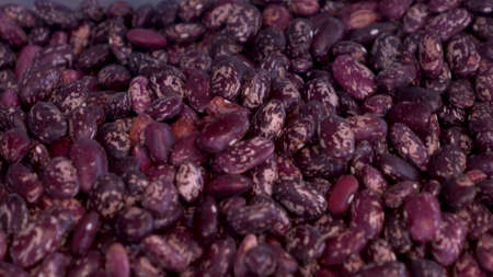 A pile of red beans on the market close-up. The camera moves.