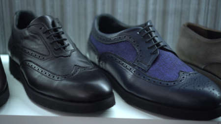 Different shoes are on the shop counter. Shoe store.の写真素材