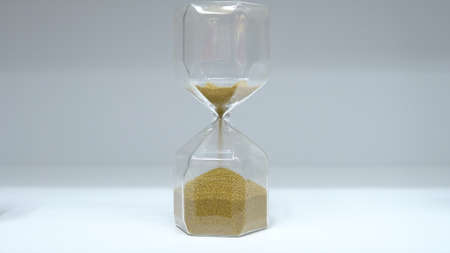 Hourglass close up. Glass hourglass with small balls instead of sand.