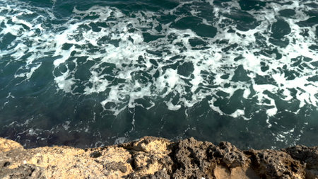 Top view of the foamy waves of the sea near the cliffs. Dark blue seaの写真素材