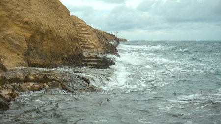 The waves beat against the rocks. Storm on the Mediterranean Sea. The sea is turquoiseの写真素材