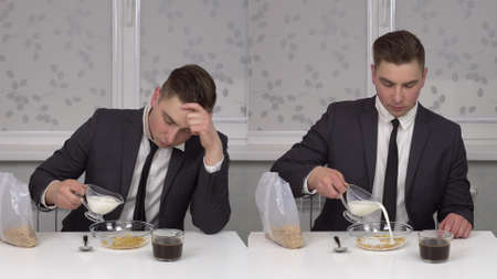 A young man in a suit eats cereal and drinks coffee, sleepy and cheerful.の写真素材