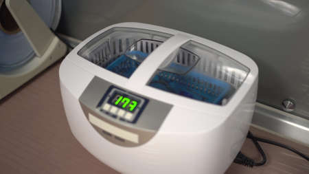 A woman puts tools in a water sterilizer. Sterilization of instruments.の写真素材