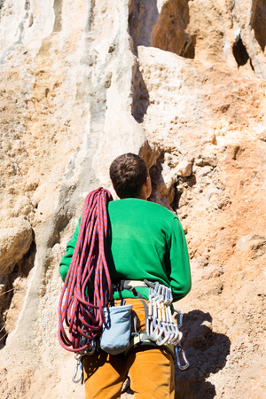 Young male climber hanging by a cliff.の写真素材