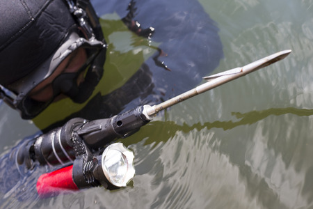 Underwater hunter dives into the sea.の写真素材