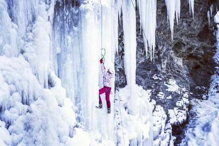 Ice climbing the North Caucasus, man climbing frozen waterfall.の写真素材