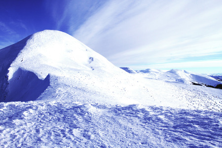 Winter hiking in the mountains on snowshoes with a backpack and tent.の写真素材