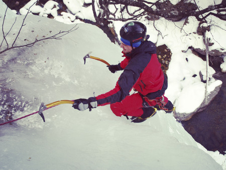 Man climbing frozen waterfall.の写真素材