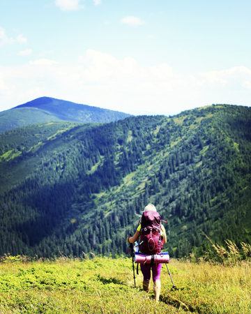 Man tourist walking the mountains with a backpack.の写真素材